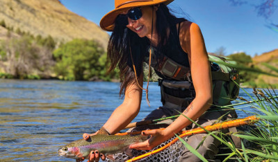 Kayla Lockhart releasing a wild trout